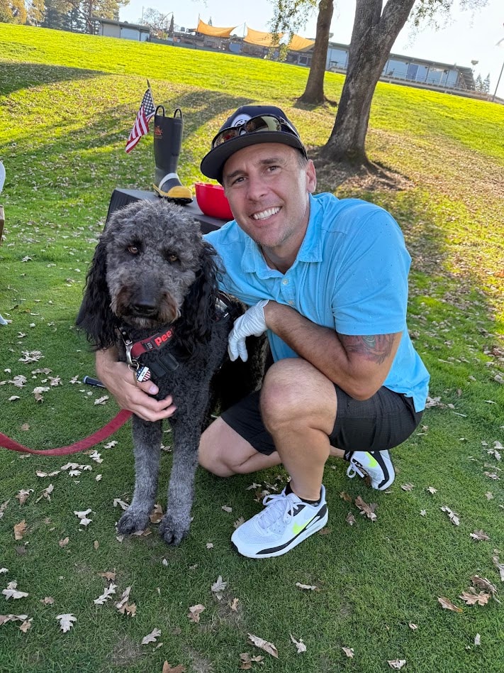 Man with service dog at golf event