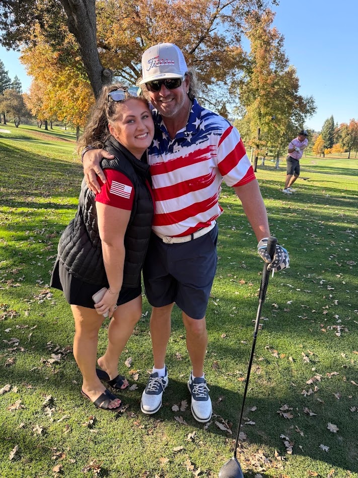Two people at golf course during Movember event