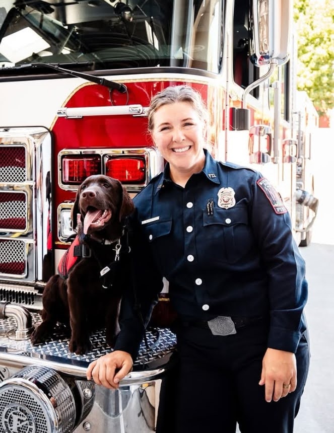 Service dog and handler training together outdoors