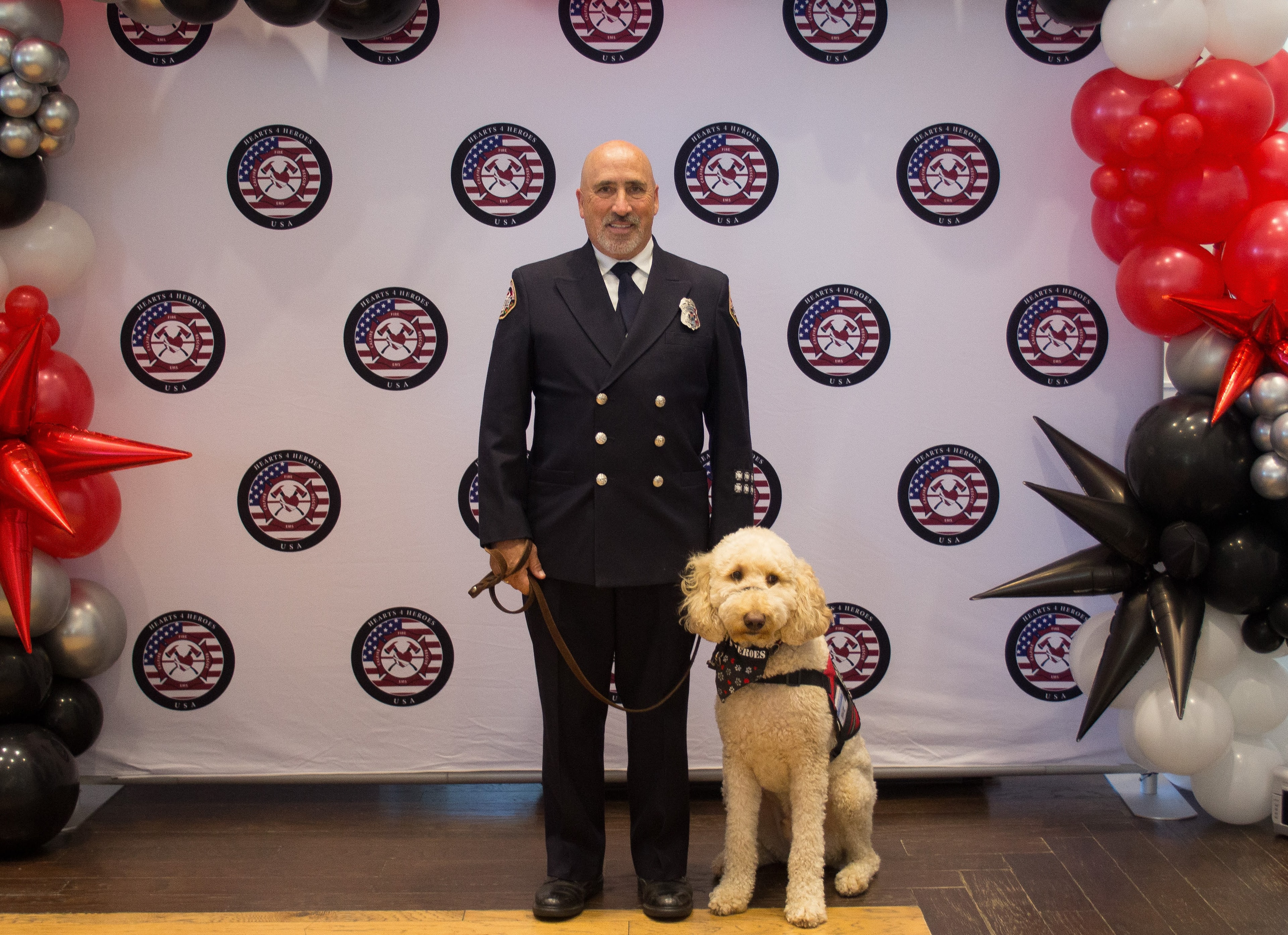 Firefighter Paramedic Dan Salois in dress uniform with Blaze at the Hearts 4 Heroes USA gala