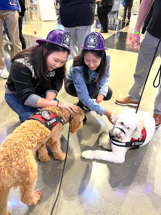 Community members petting Captain Charlie at a Hearts 4 Heroes event