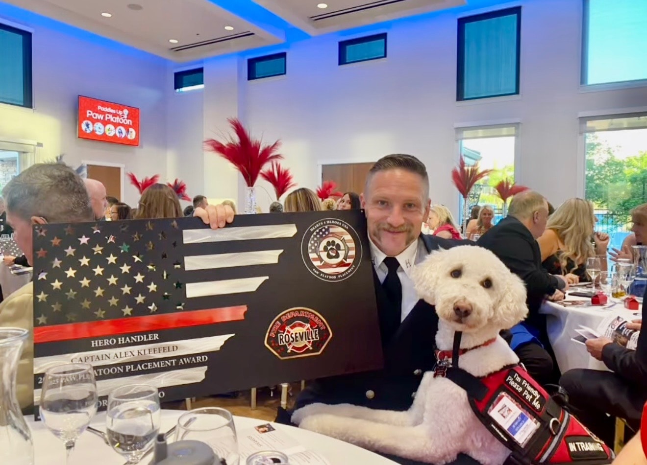 Engineer Alex Kleefeld receiving the Hero Handler award with Captain Charlie at the Hearts 4 Heroes Gala